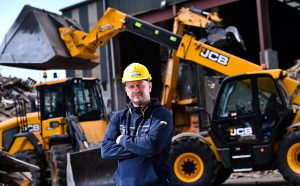 Pictured is Managing Director Mark McKinstry infront of new JCBs at the site in Belfast Brief.  McKINSTRY KEEPS PRODUCTIVE WITH EXPANDING JCB FLEET Up until four years ago, McKinstry Skip Hire, had never bought a JCB. Now, Northern Ireland’s leading waste management company runs a fleet of 14 – all supplied by local dealer BC Plant.  Sourcing a large fleet of materials handling machines from a single supplier helps McKinstry to maximise productivity at its growing operations. This is not only because the machines are designed to handle the waste and recycling environment but also, McKinstry need only turn to one source for support to maintain uptime for its entire fleet.  The latest additions to its materials handling fleet include a 437 wheeled loading shovel, two Wastemaster Loadalls – a 560-80 and a 531-70 – and a JS131 tracked excavator. Another recent acquisition was a JS20MH material handler. With this excavator, which has a 20,720 kg maximum operating weight, the operator can gain greater visibility over a site and high piles of waste thanks to its hydraulically-raised cab. As manager of McKinstry, Mark McKinstry points out: “JCB offers a good range of waste-spec machines.”  McKinstry specialises in waste management and recycling, skip hire, waste services, biomass, Duty of Care and quarry products. From its plants in Nutts Corner, Belfast and Portadown it provides cost effective and efficient waste solutions to both the public and private sectors. It is a specialist in the collection and recycling of dry waste and all construction and demolition waste streams. Seven JCB machines work at the Nutts Corner facility, which is McKinstry’s main site and where it has made significant investments in its Material Recovery Facility (MRF). With the company striving towards achieving zero waste to landfill, it is playing a significant role in the development of sustainability in Northern Ireland. A decade ago, 90% of all the waste collected by McKinstry from across Northern Ireland went straight to landfill. That’s been reversed with over 90% of waste now being recycled – with a broad variety of waste streams leaving its MRF for destinations across the globe. More . . . 2/ . . .	 “We are very busy with a throughput of 250-300 skips per week – and that’s just the skips part of the business,” says McKinstry. The company also happens to be Northern Ireland’s biggest producer of Biomass. “We receive a lot of waste from third parties and are contracted to biomass through Stobart Biomass.”  Commingled waste received by McKinstry is loaded into a shredder, using the JCB JS20 material handler, to give a consistent size. A variety of recovered recyclable materials are exported worldwide and the residual waste is processed into clean, dry one-tonne square bales of RDF (Refuse Derived Fuel), which Stobart then delivers to consumers. The materials handling machines are vital in keeping all of McKinstry’s operations productive, as Mark McKinstry explains: “Our JCB machines are very reliable; they are powerful and we have good service and back-up so there’s no down time – that’s important.”  Among the waste-spec features on JCB’s machines that Mark McKinstry highlights as being advantageous for working on the company’s sites are the maintenance-free solid tyres, which are a big contributor to uptime. He also cites the safety reversing cameras, immobilisers and ground clearance that allows the machines to drive over waste easily. McKinstry is also keen to keep the fleet operating at optimum productivity by not racking up the hours on the hard working machines. “We have a programme to replenish our JCB machines because we don’t want to put a high number of hours on them – some of our machines can have up to 7,000 hours on them,” says McKinstry. “We now want to replace our machines after 2500 hours, which is the secret to running efficient machines.” And with JCB taking care of this efficiency, McKinstry is free to focus on continuing its successful growth.
